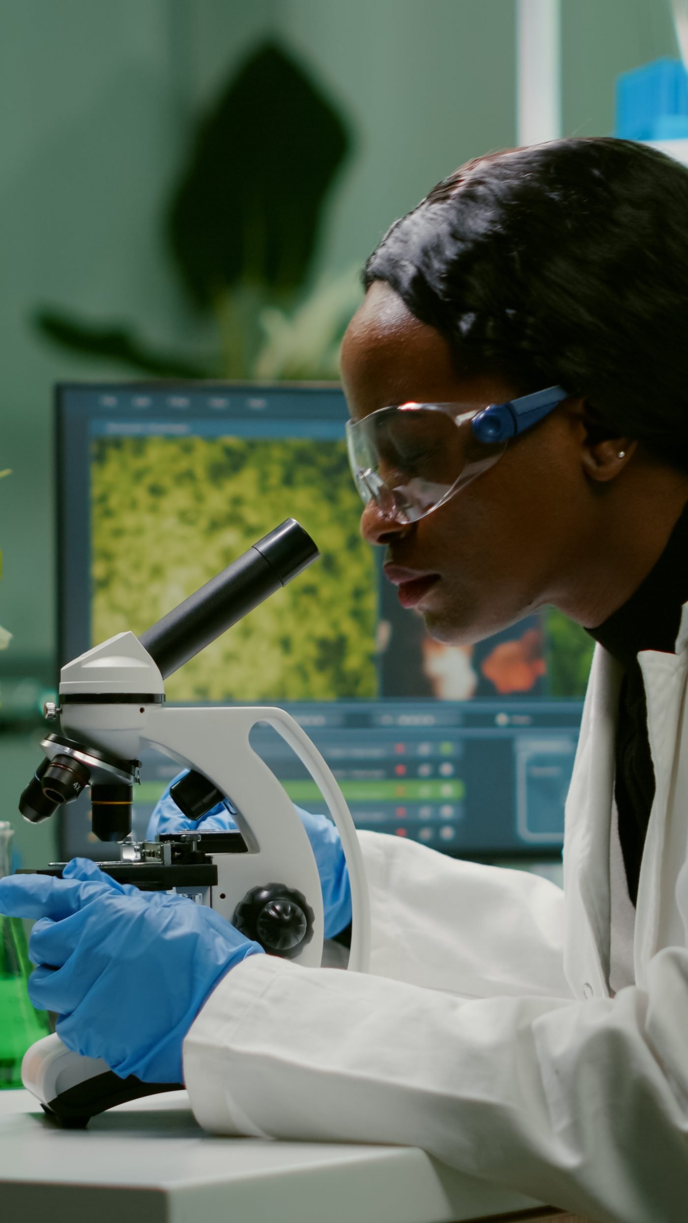 Biologist examining a sample under a microscope
